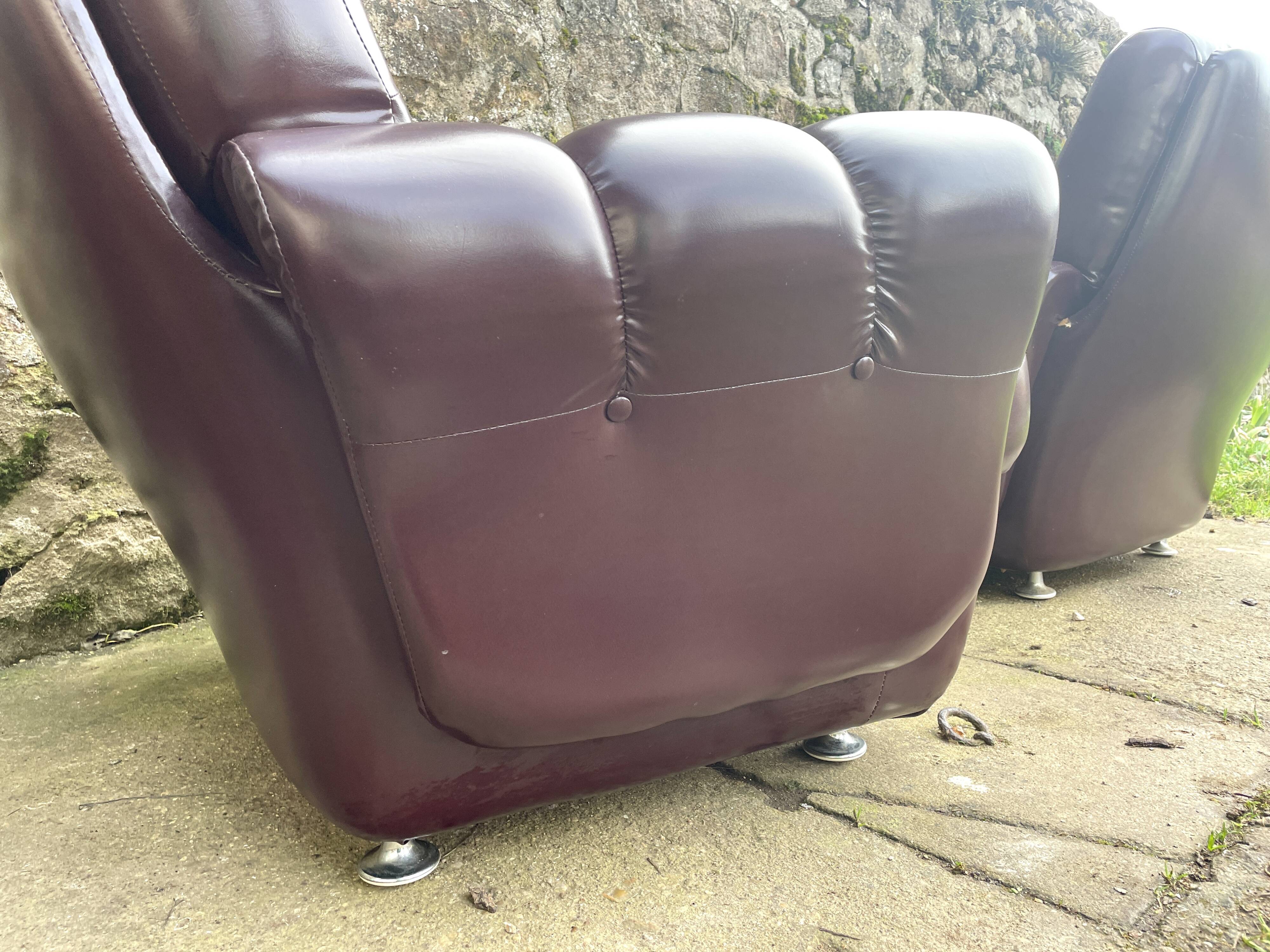 Pair of upholstered armchairs in aubergine imitation leather