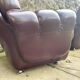Pair of upholstered armchairs in aubergine imitation leather