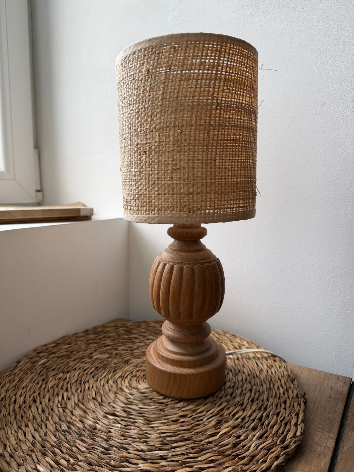 Antique table lamp with a carved wooden base.