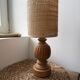 Antique table lamp with a carved wooden base.