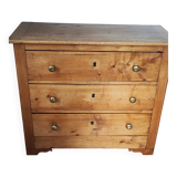 Rustic English pine chest of drawers with porcelain knobs.