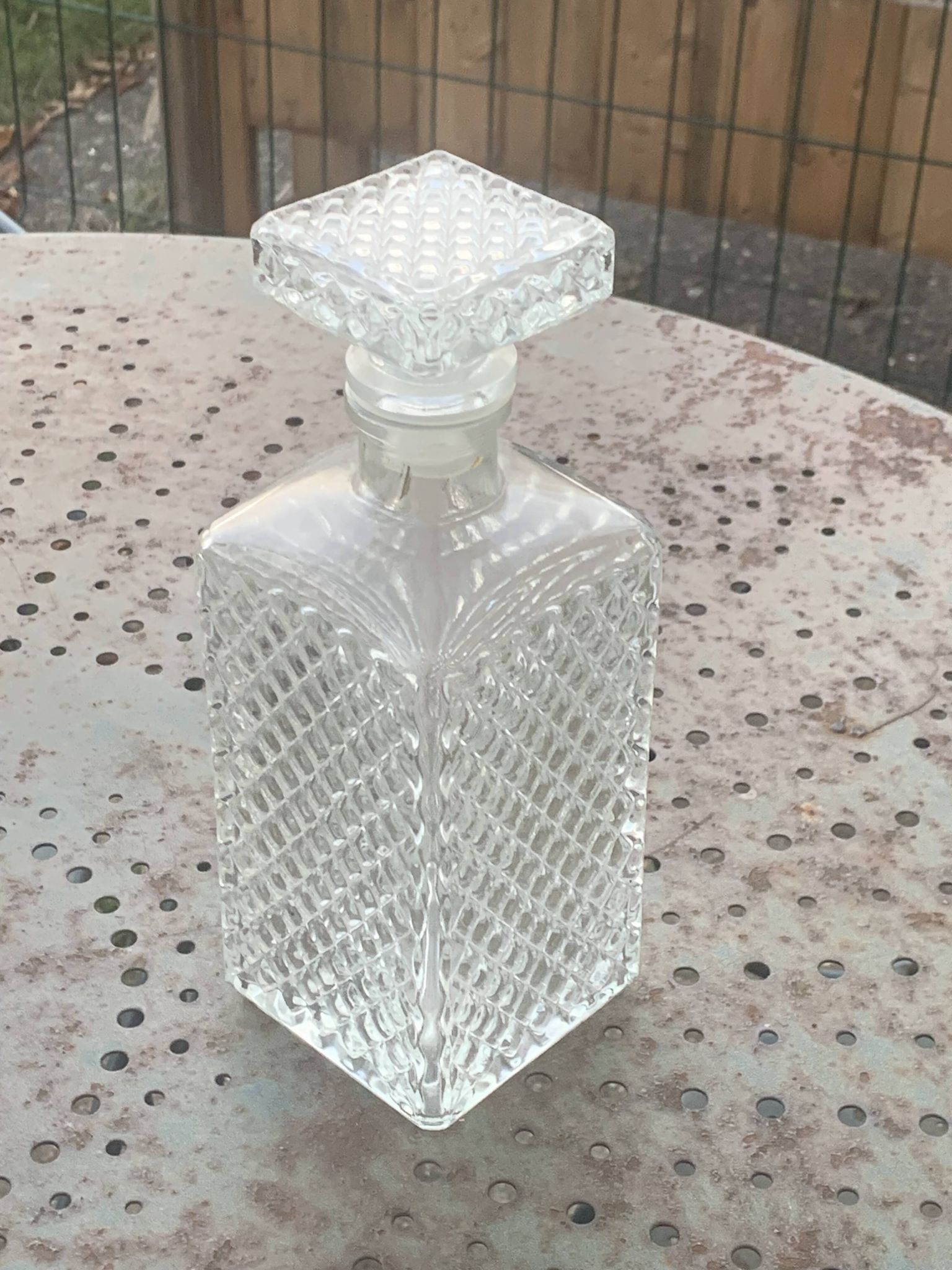 Whiskey carafe and ice bucket in transparent glass and silver-colored metal handle