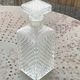 Whiskey carafe and ice bucket in transparent glass and silver-colored metal handle