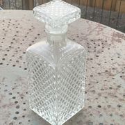 Whiskey carafe and ice bucket in transparent glass and silver-colored metal handle