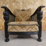 Old armchair upholstered in velvet, carved and caned wood