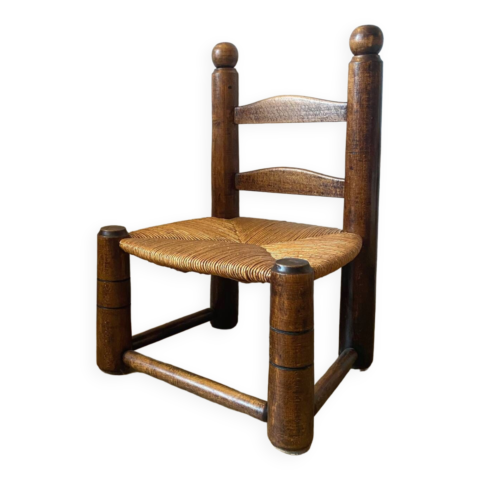 Low brutalist straw chair called fireplace chair