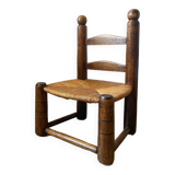 Low brutalist straw chair called fireplace chair