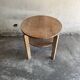 Art Deco round oak side table in light weathered oak with lower shelf, geometric three-leg design