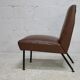 Low chair, circa 1950. Brown imitation leather.