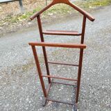 Valet wearing double wood coat rack