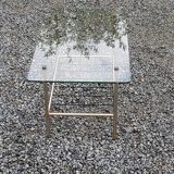 Vintage coffee table in gold and blackened metal with glass top from the 60s