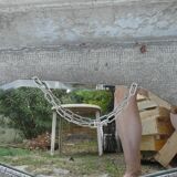 Beveled mirror with art-deco wrought iron frame and floral decor with hanging chain