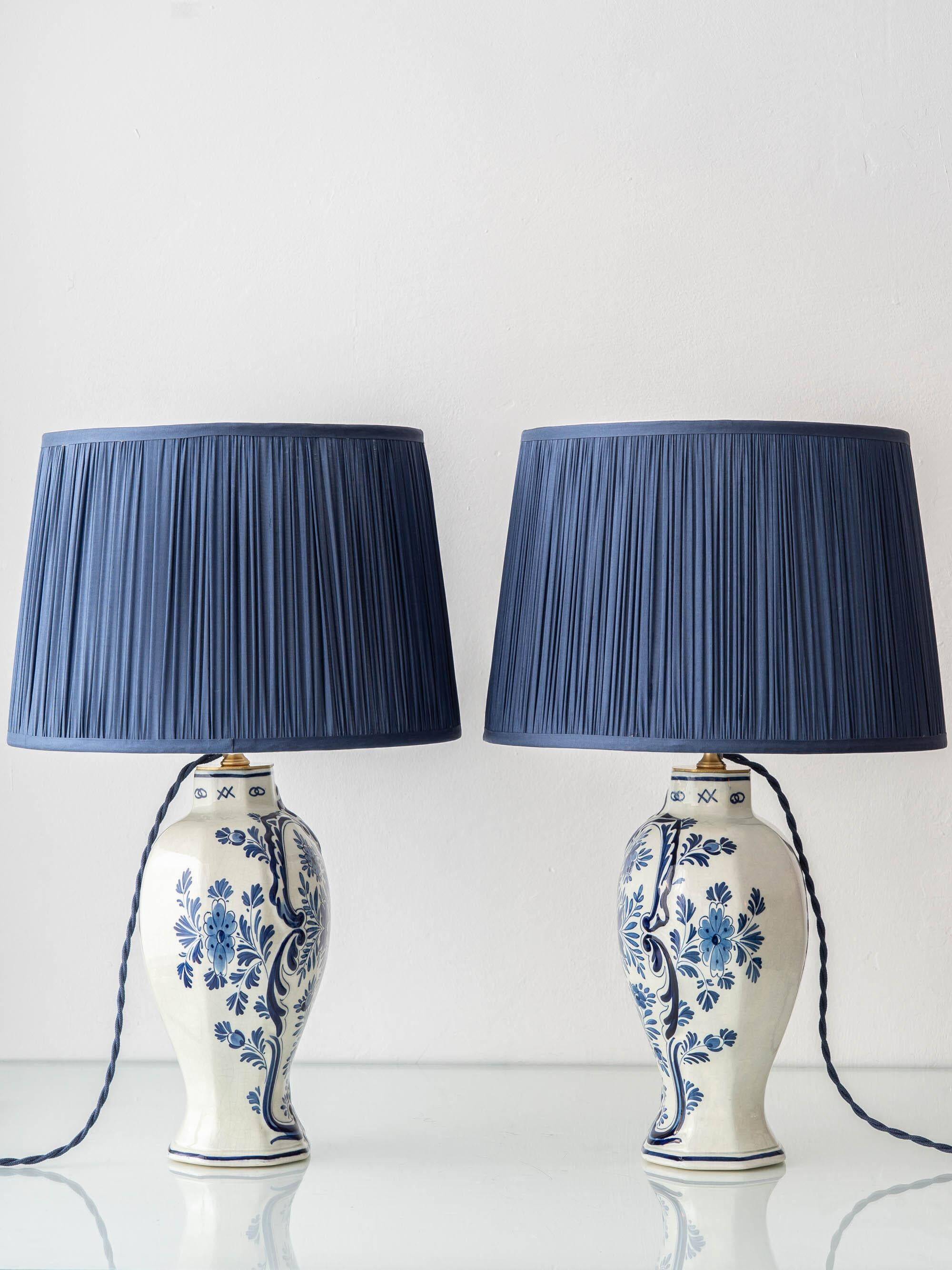 Pair of Royal Delft blue and white ceramic table lamps, 1905, with new pleated silk shades.