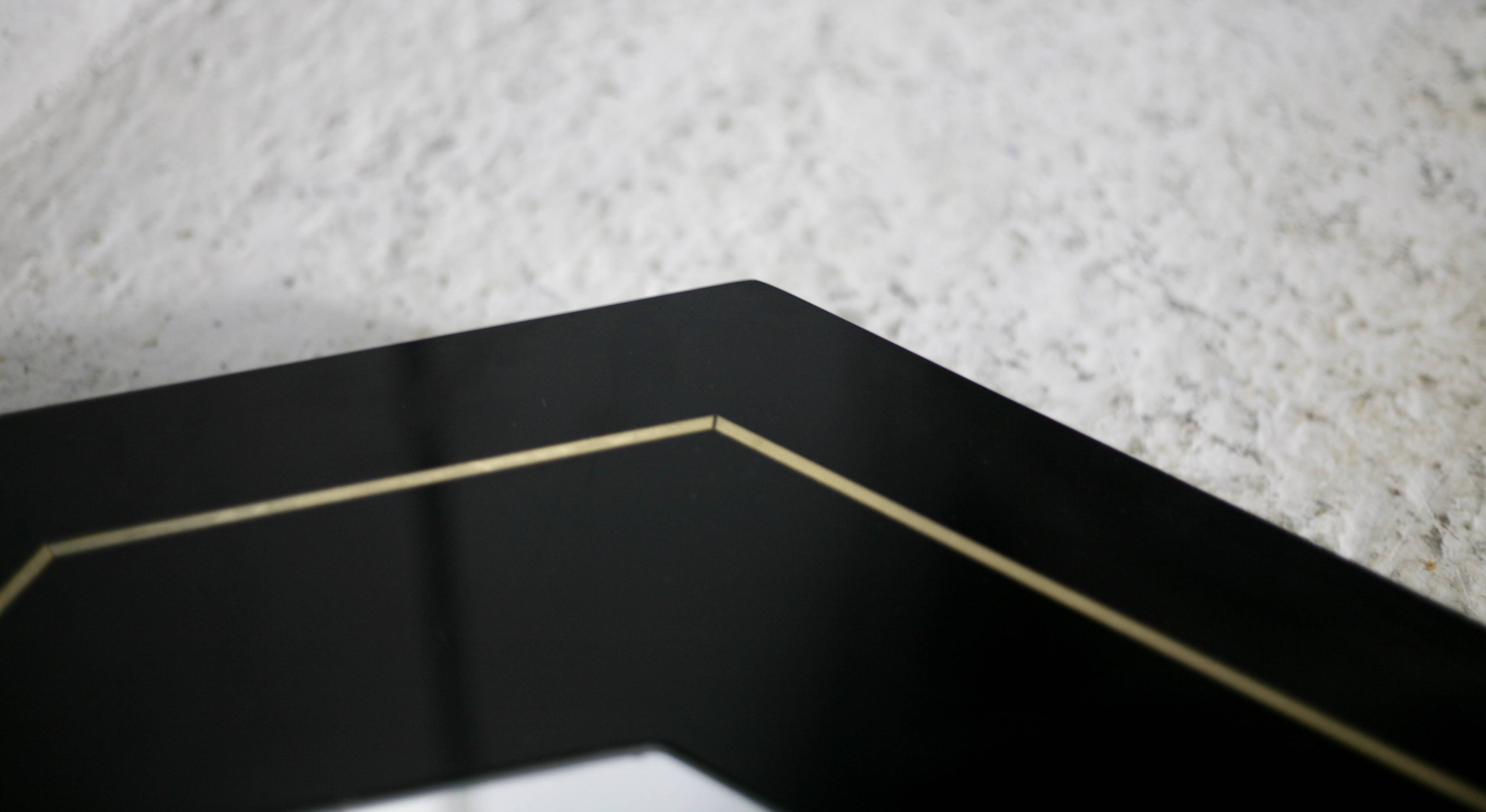 70s mirror, black lacquered wood, brass edging. Octagonal