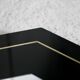 70s mirror, black lacquered wood, brass edging. Octagonal
