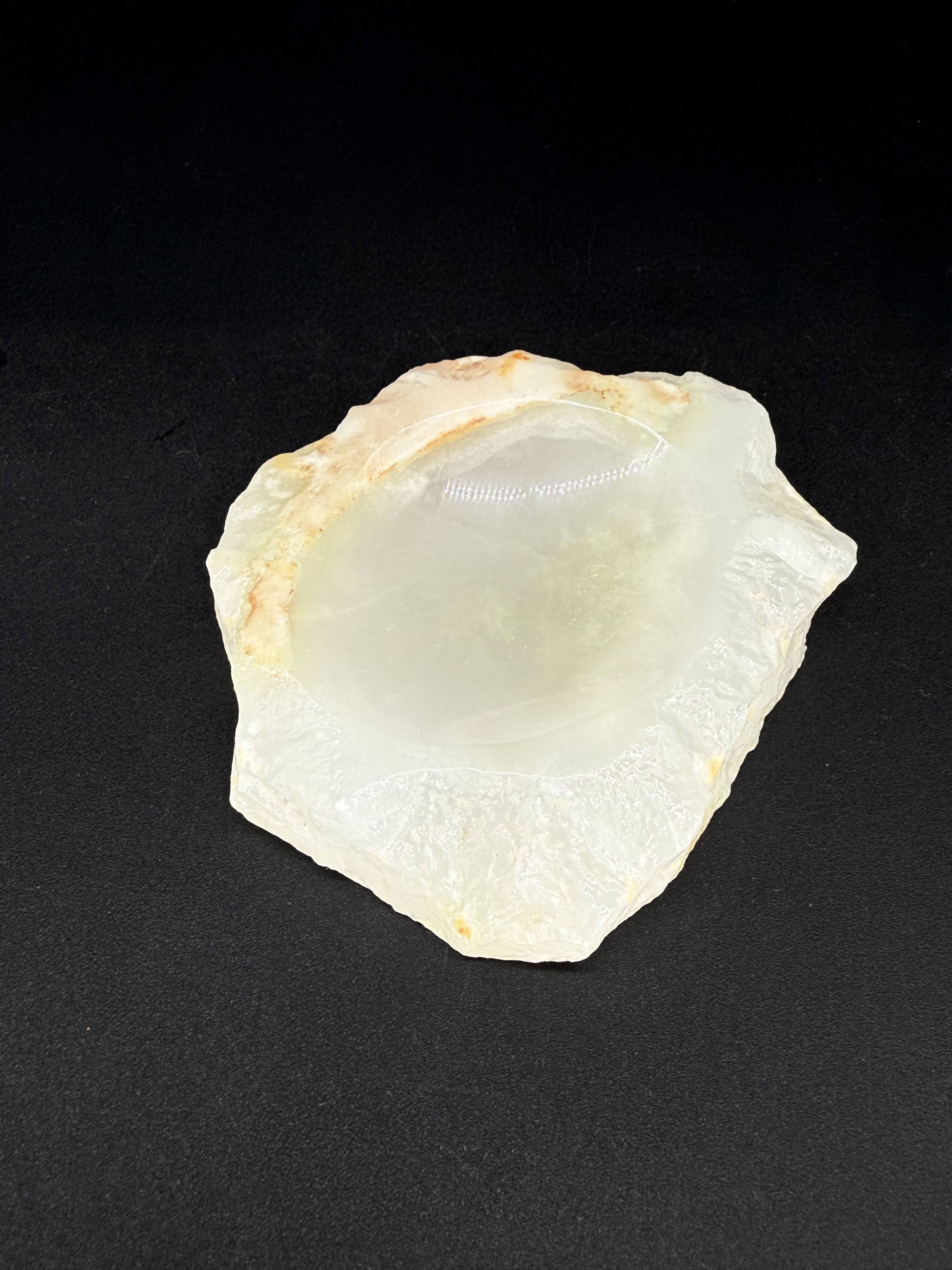 Empty pocket bowl made of translucent natural stone.