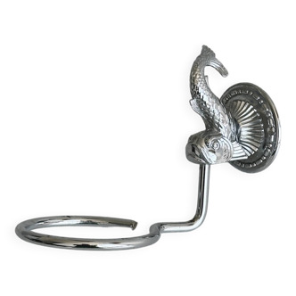 Metal napkin holder with fish-shaped decoration.