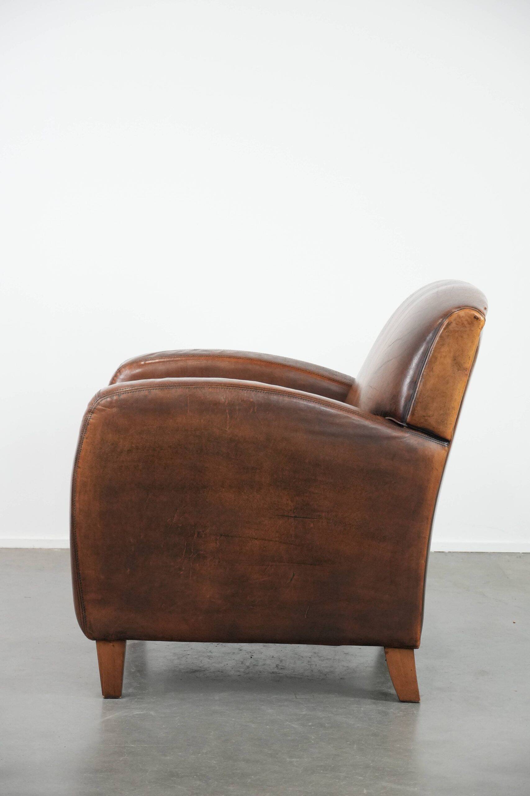 Characterful vintage sheepskin leather armchair with beautiful colours