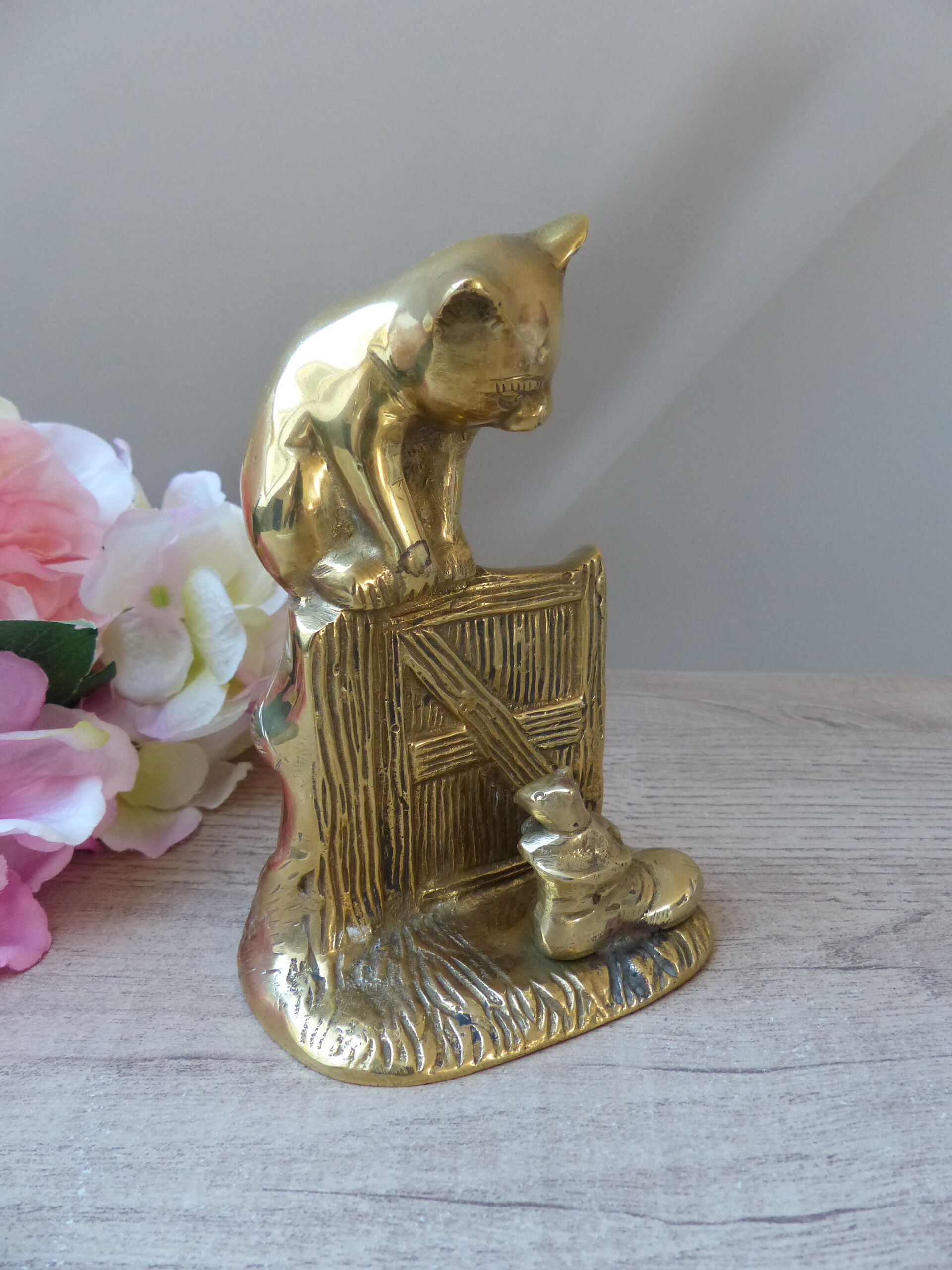 Golden brass cat figurine on fence looking at a mouse in a Vintage India shoe