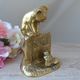 Golden brass cat figurine on fence looking at a mouse in a Vintage India shoe