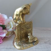 Golden brass cat figurine on fence looking at a mouse in a Vintage India shoe