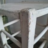 Vintage wooden stool with white peeling paint