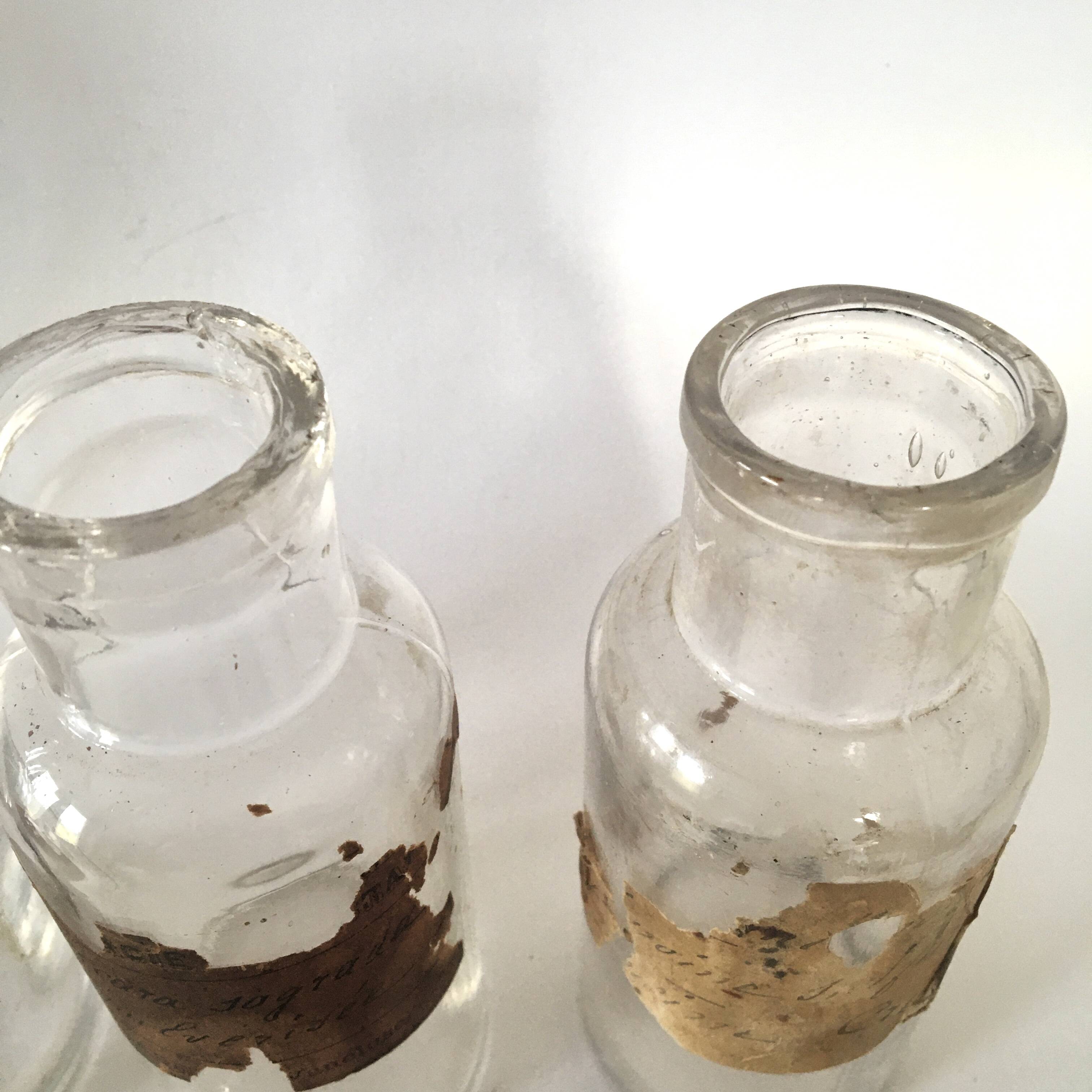Trio apothecary bottles, painted metal caps