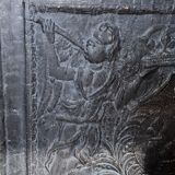 huge old fireplace plate has decoration of angels, crown and fleurs-de-lis