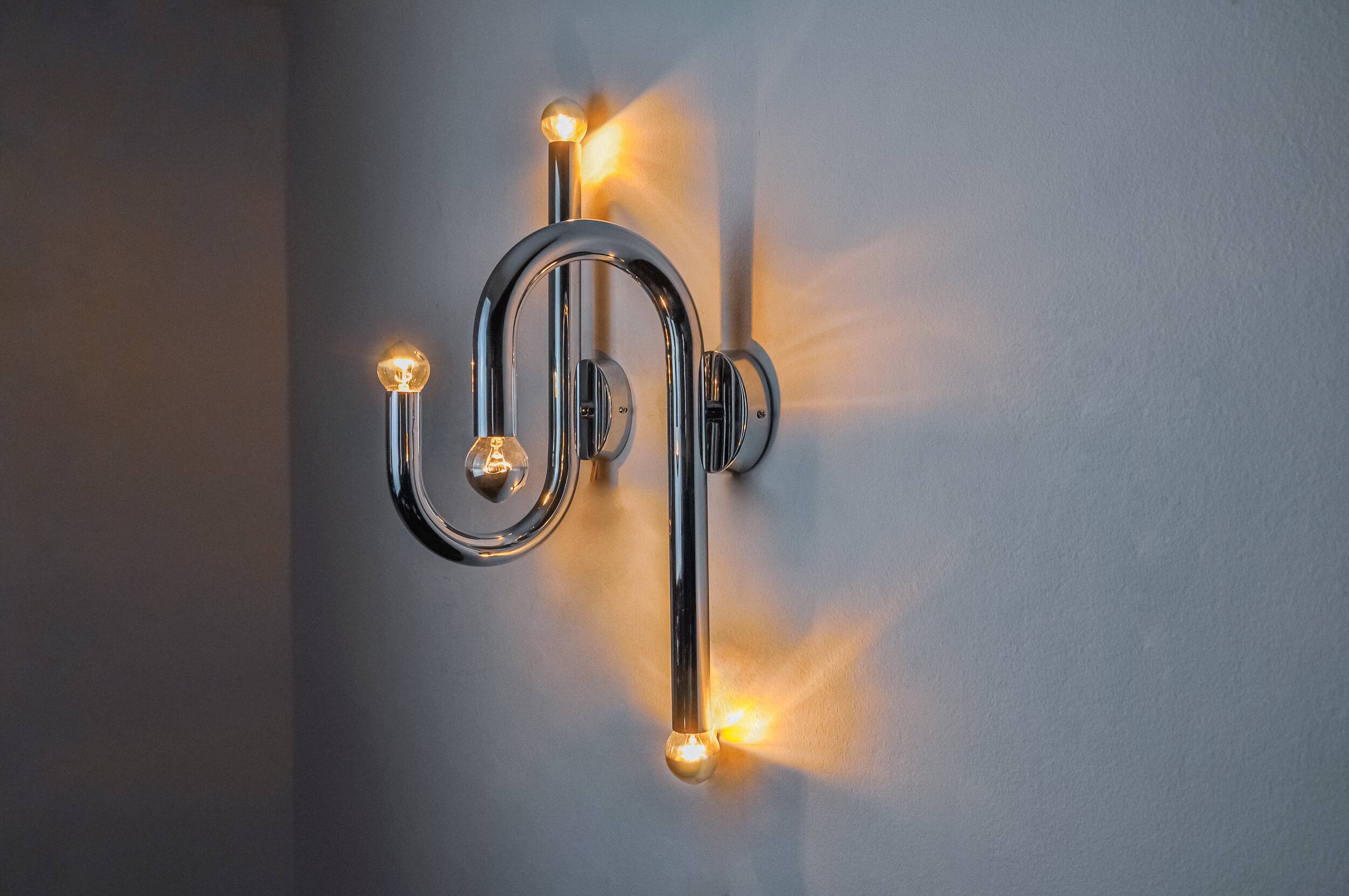 Pair of space-age tubular wall lights, chromed metal, Italy, 1970