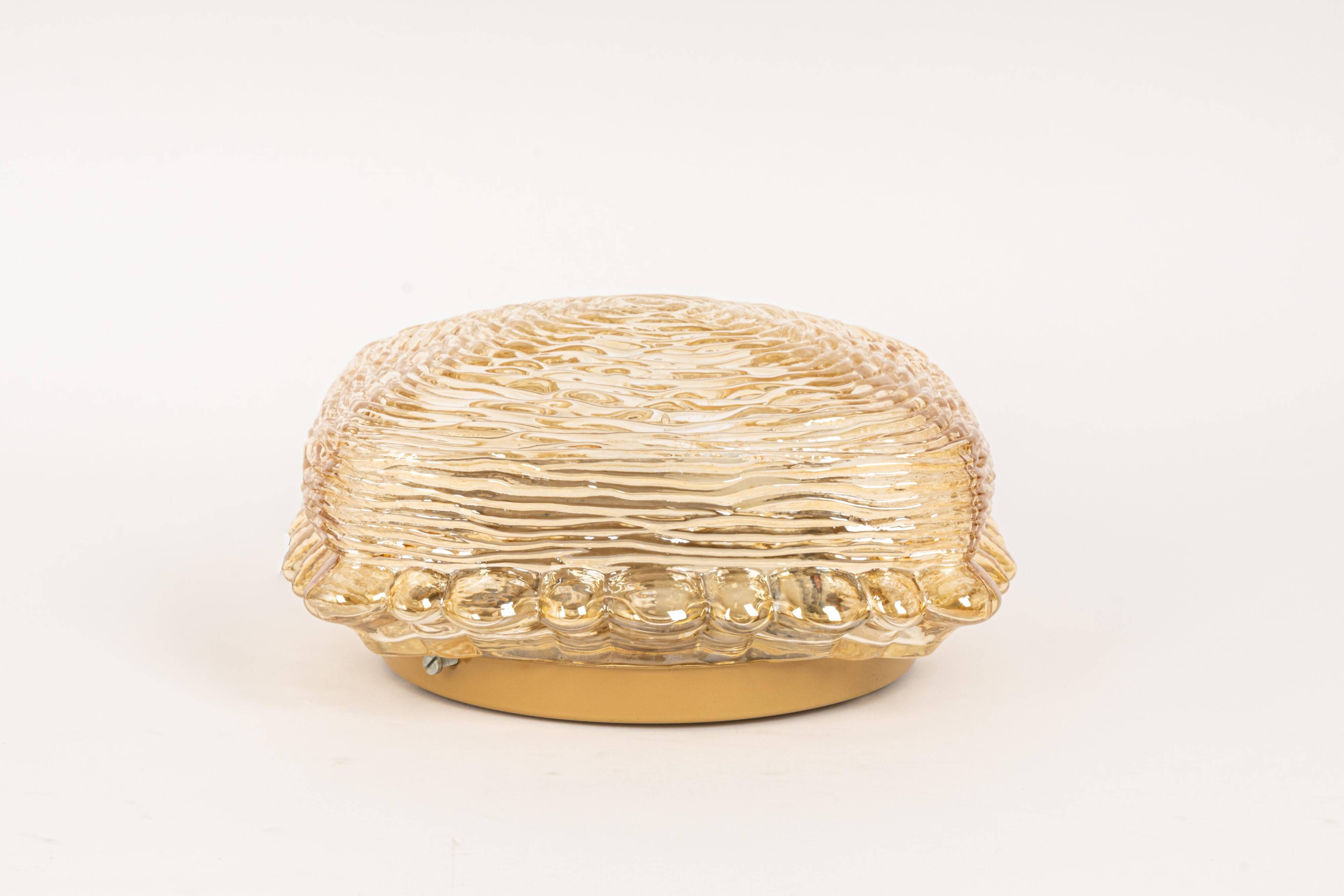 Pairs of amber glass wall lights in the shape of a fingerprint, Germany, 1970s.