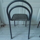 Indus chair with tubular structure in slate gray metal waxed finish, upholstered seat.
