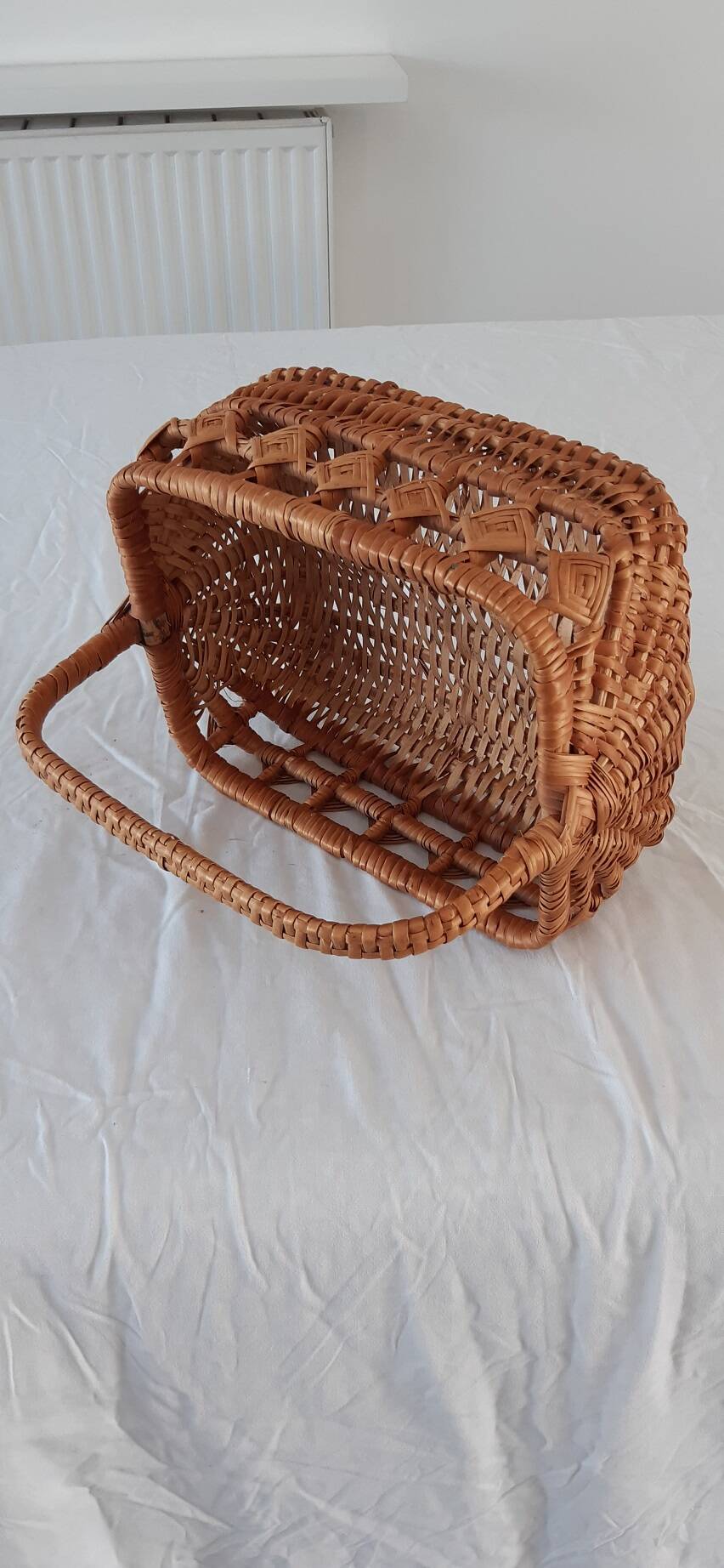 Old wicker basket with diamond-shaped decorations