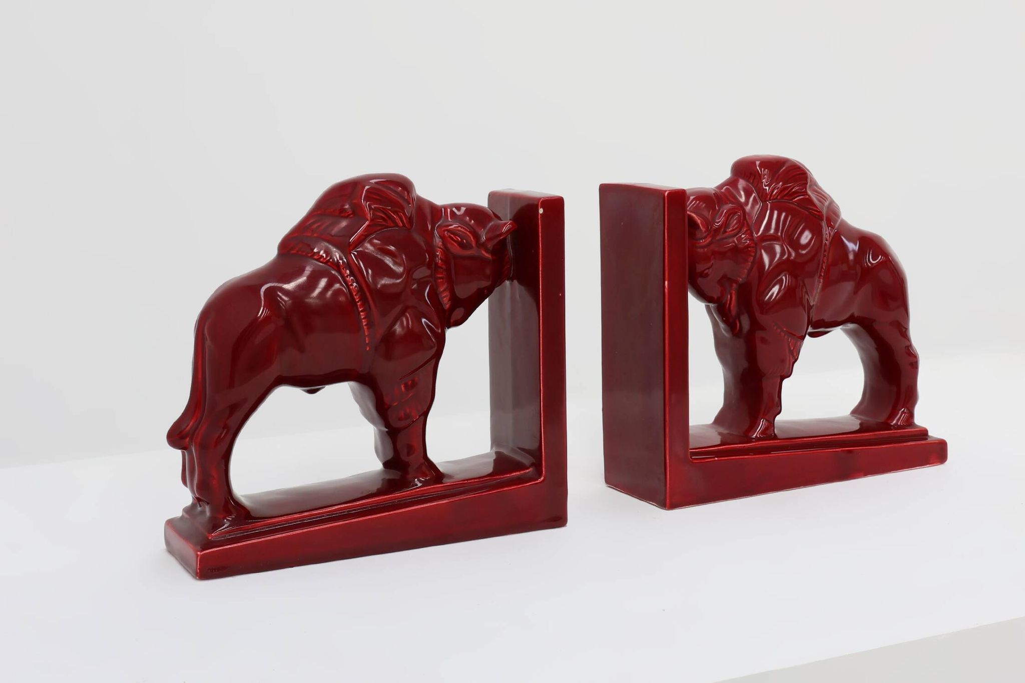 Pair of red glazed ceramic Bison ox bookends in Art Deco style, Belgium