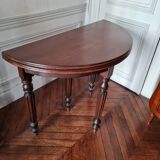Family half-moon table in walnut hue.