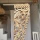 Indonesian construction element in carved wood with intertwined plant motifs mounted on a base (fri