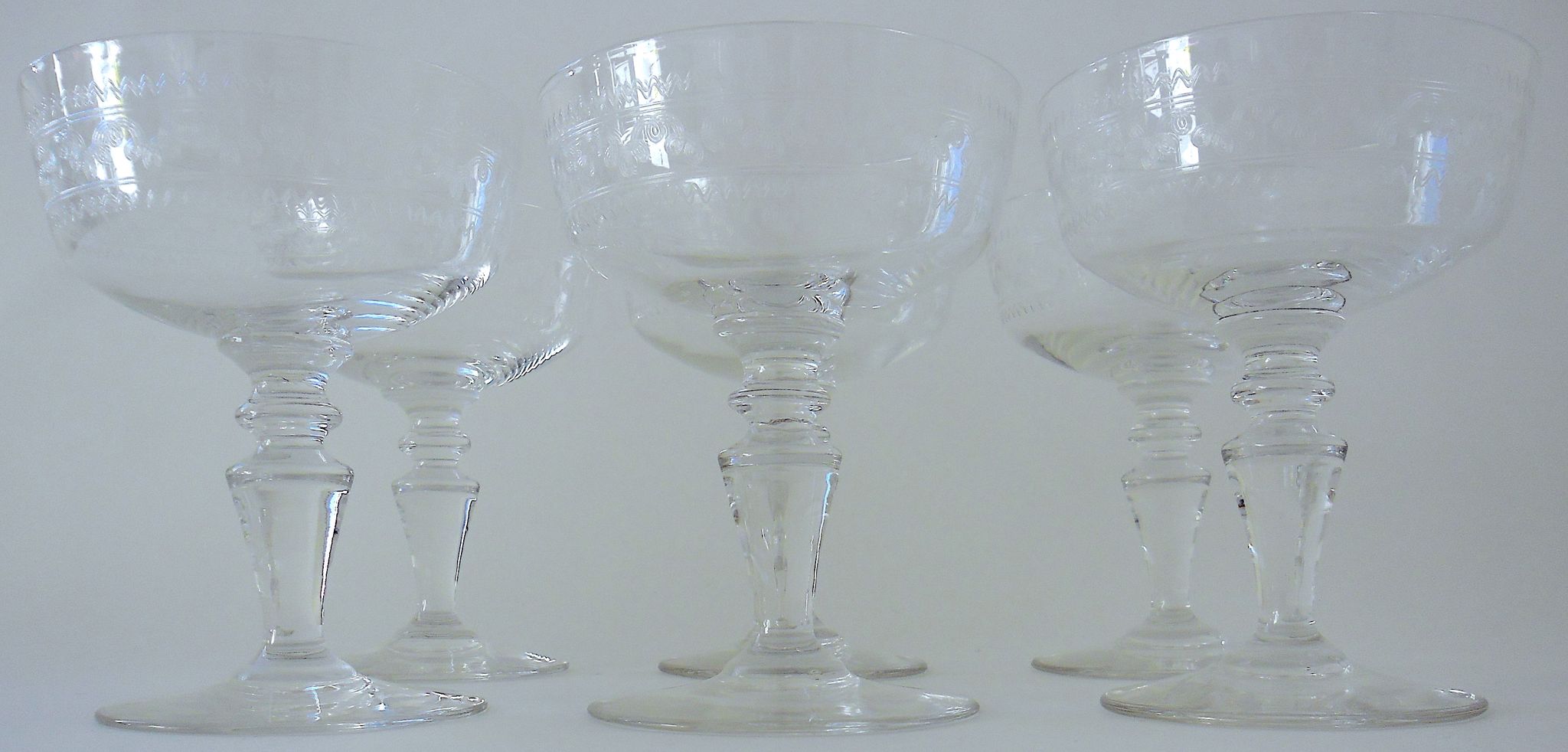 Suite of six champagne glasses on foot in engraved colorless crystal