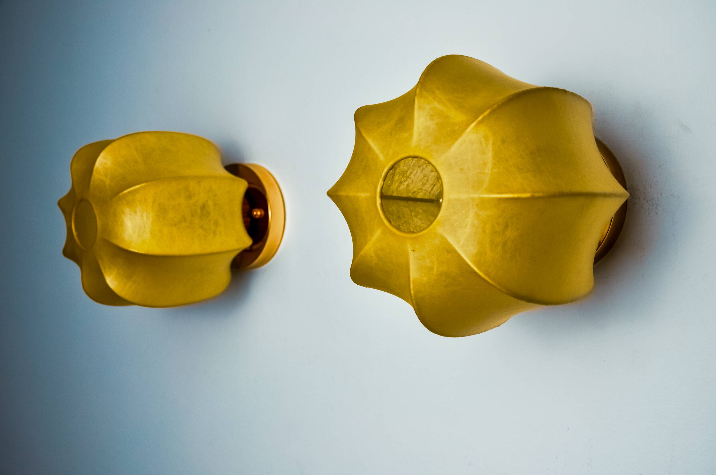 Pair of circular "cocoon" wall lights, resin and pine, Italy, 1970