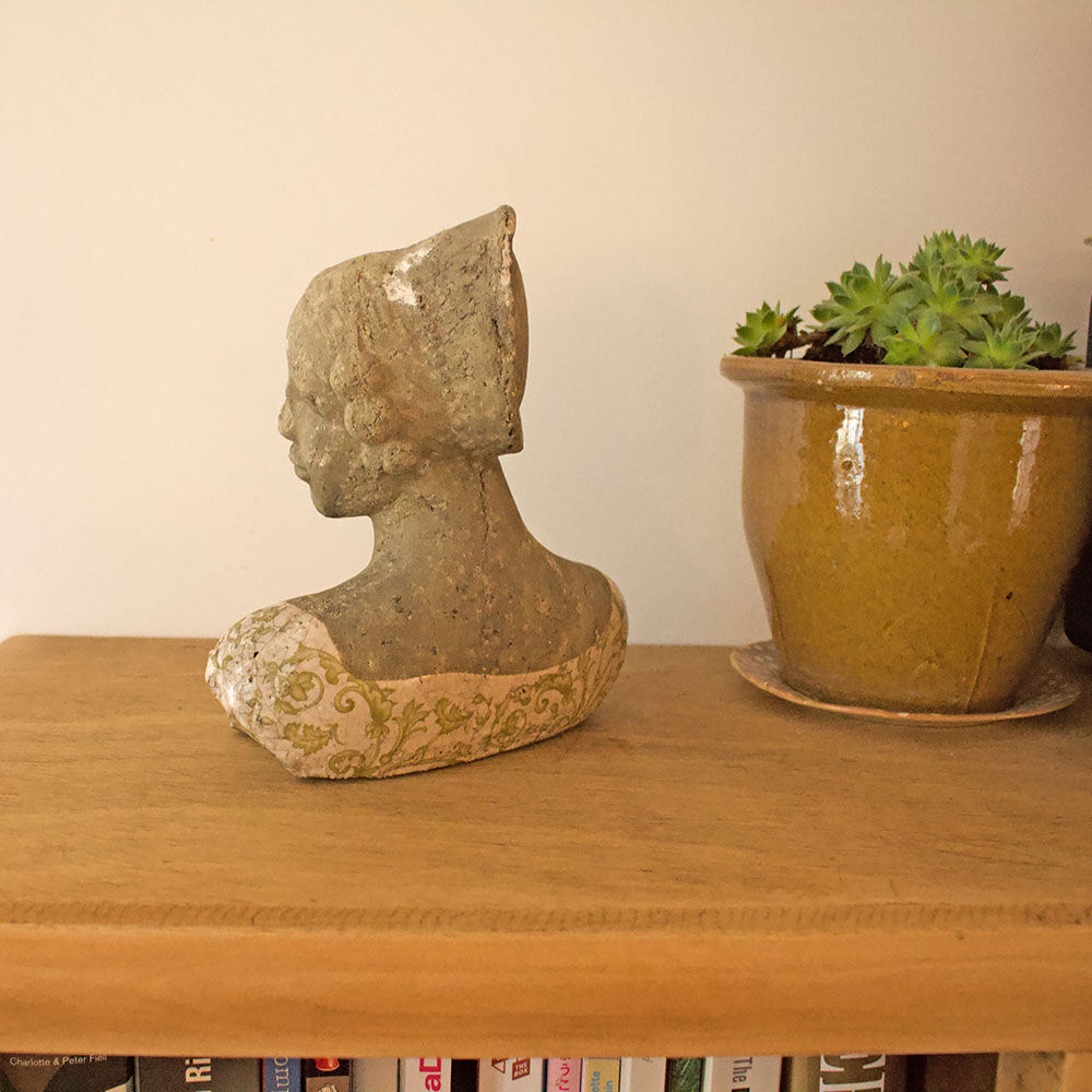Woman bust in stone and enamel