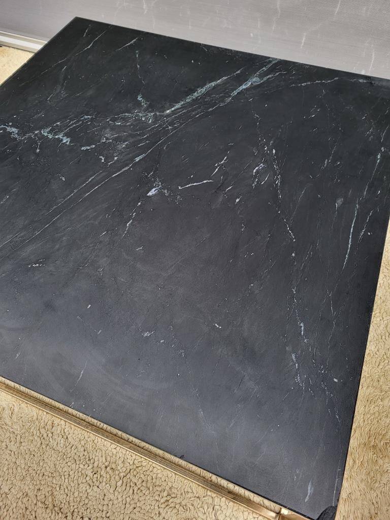 Coffee table or black marble and brass display "in its own juice"