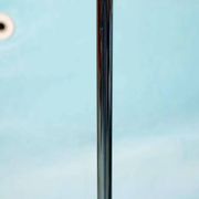 Vintage floor lamp in milky glass and chrome, minimalist uplight lighting.
