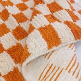 Orange checkered rug made entirely by hand