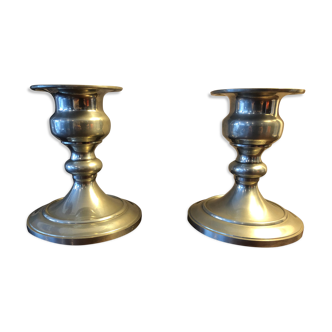 Duo of old tin candlesticks
