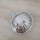 Shell-shaped butter dish in stainless steel and white glass bowl.