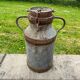 Old metal can or milk jug