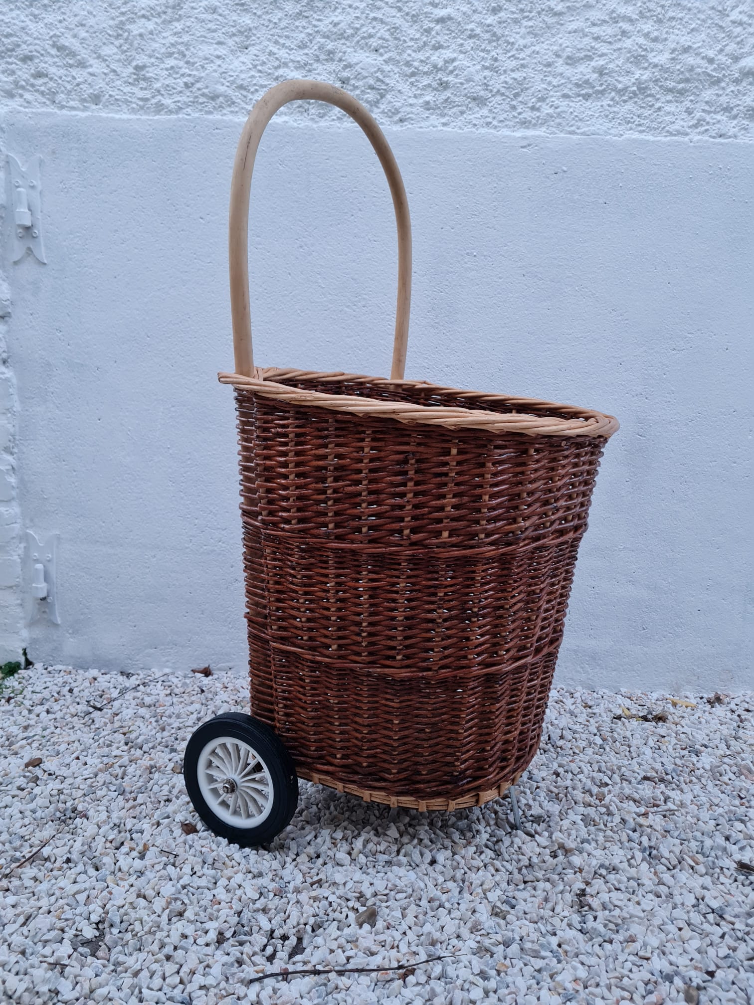 Vintage wicker log basket on vintage wheels