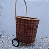 Vintage wicker log basket on vintage wheels