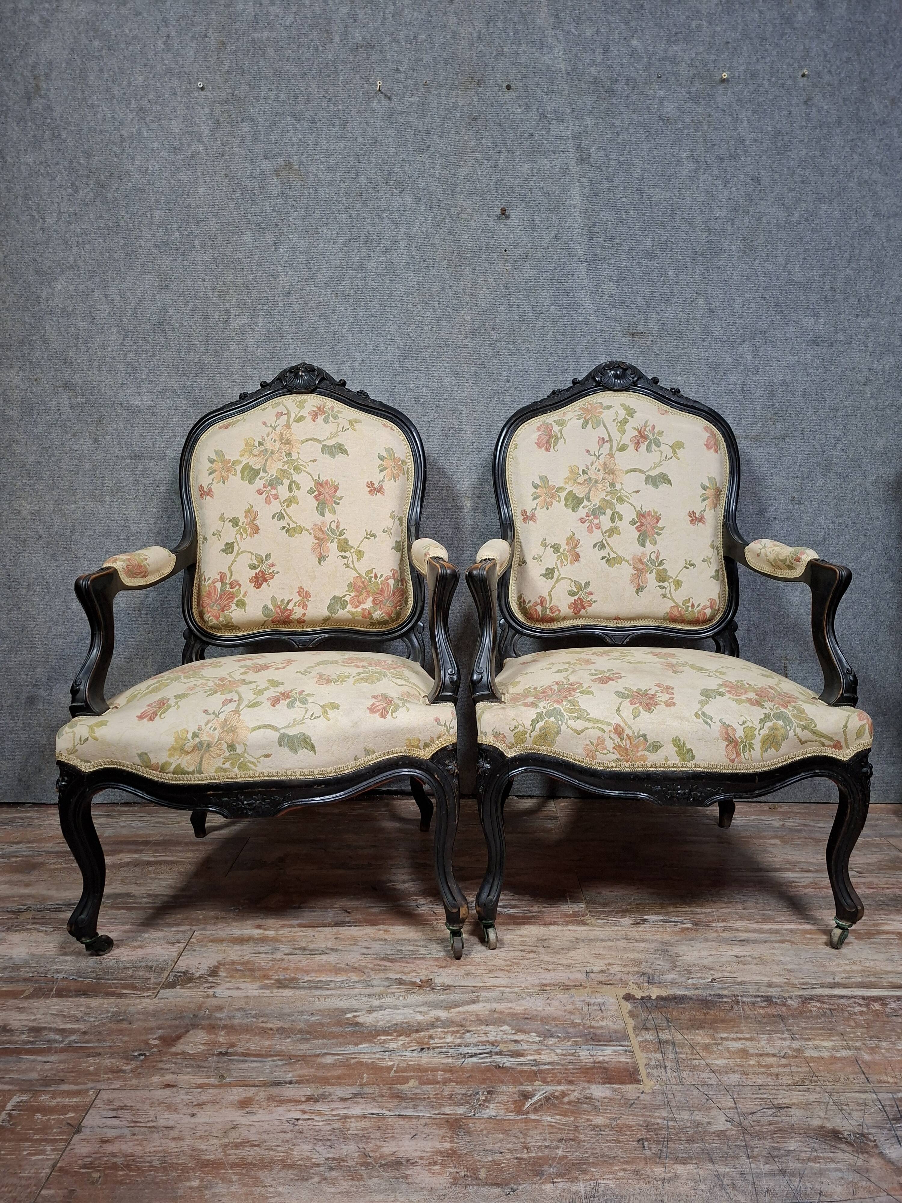 pair of Louis XV style armchairs, in moulded and carved wood, lacquered black