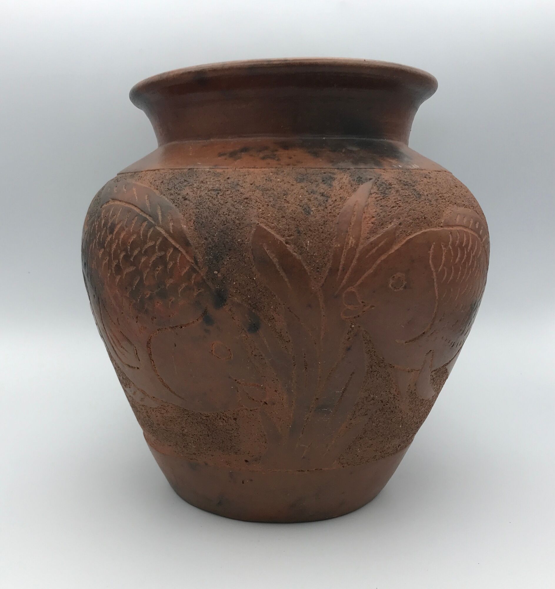 Vase or pot in brown terracotta with artistic decoration of fish.