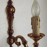 Simple wall sconce in classic Empire style in vintage French bronze.
