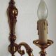 Simple wall sconce in classic Empire style in vintage French bronze.